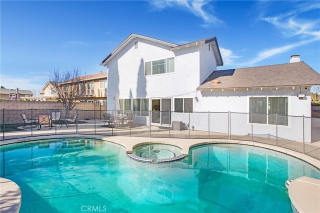 view of swimming pool featuring an in ground hot tub and a patio