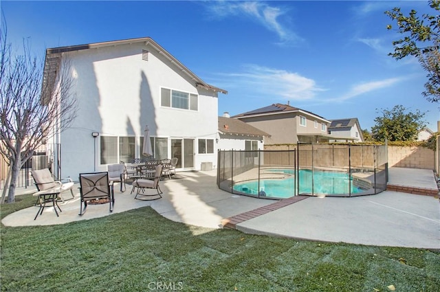 view of pool featuring a lawn and a patio