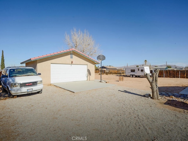 view of front of property featuring an outbuilding and a garage