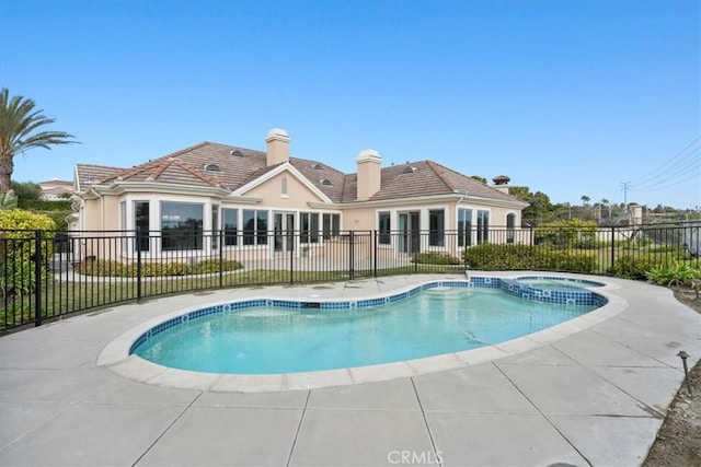 view of pool with an in ground hot tub