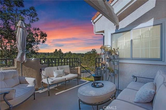 balcony at dusk with an outdoor hangout area