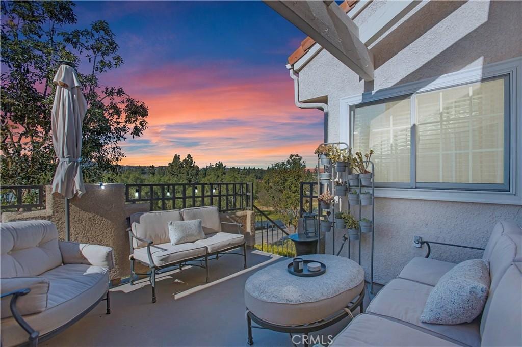 balcony at dusk with outdoor lounge area