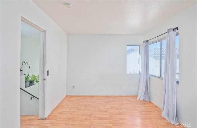 spare room with light hardwood / wood-style floors