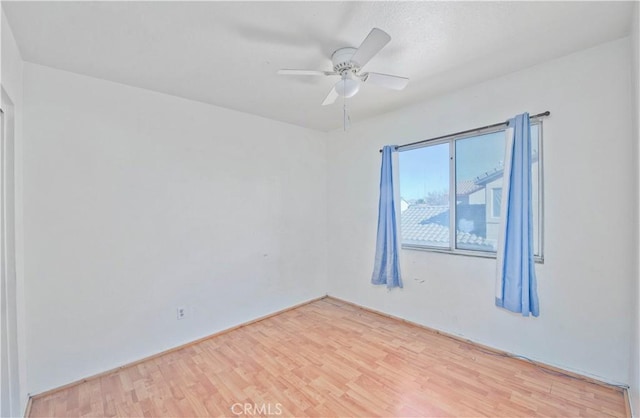 unfurnished room featuring ceiling fan and hardwood / wood-style floors