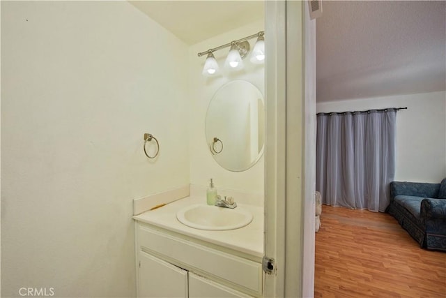 bathroom featuring vanity, a textured ceiling, and hardwood / wood-style flooring