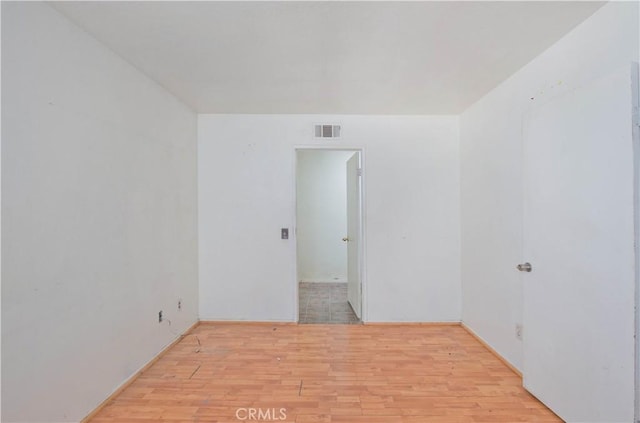 unfurnished room with light hardwood / wood-style floors