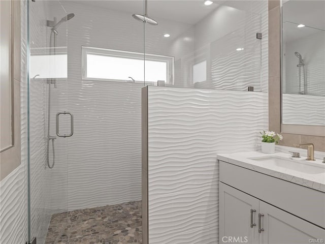 bathroom featuring vanity and a shower with shower door