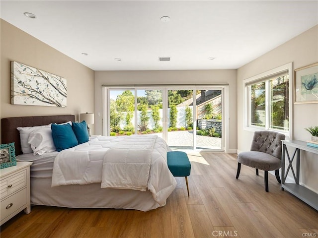 bedroom with access to outside and light hardwood / wood-style floors