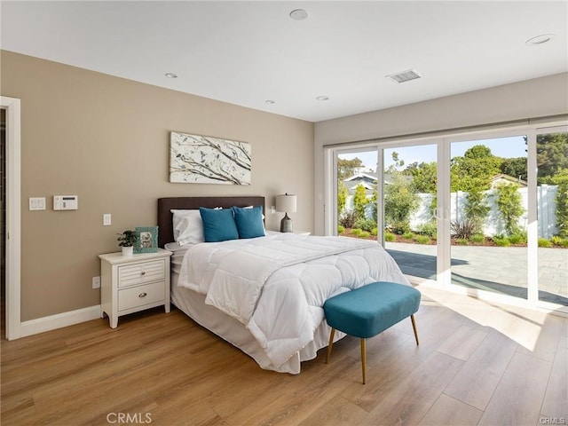 bedroom featuring access to outside and light hardwood / wood-style floors