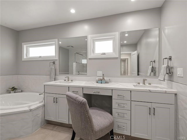 bathroom with tile patterned flooring, vanity, and separate shower and tub