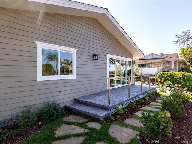 rear view of property featuring a deck