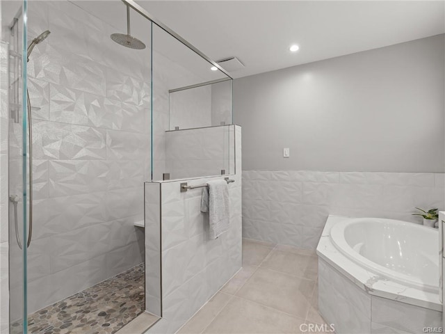 bathroom with tile patterned floors and independent shower and bath