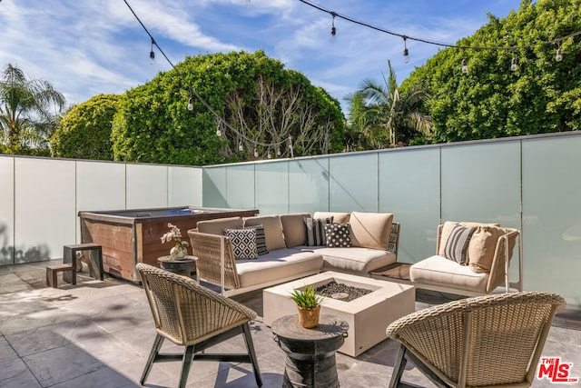 view of patio / terrace featuring an outdoor living space with a fire pit