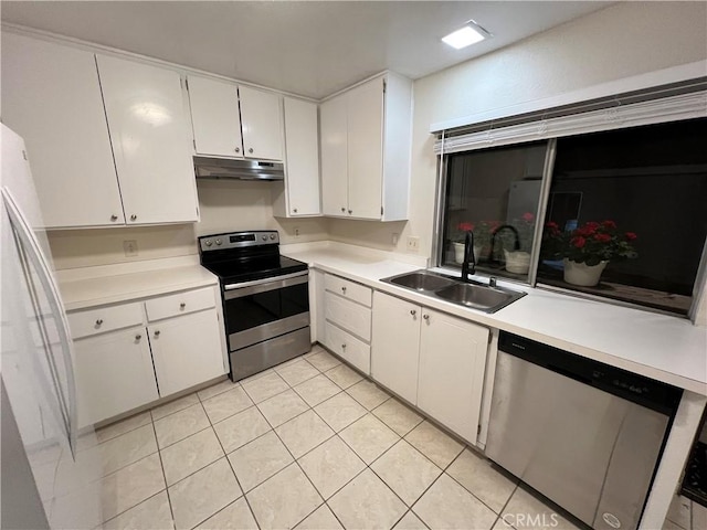 kitchen featuring white cabinets, appliances with stainless steel finishes, sink, and light tile patterned floors