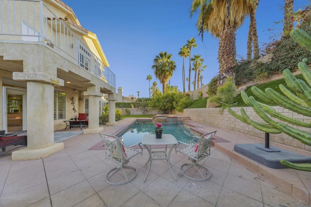 view of swimming pool with a patio area and an in ground hot tub