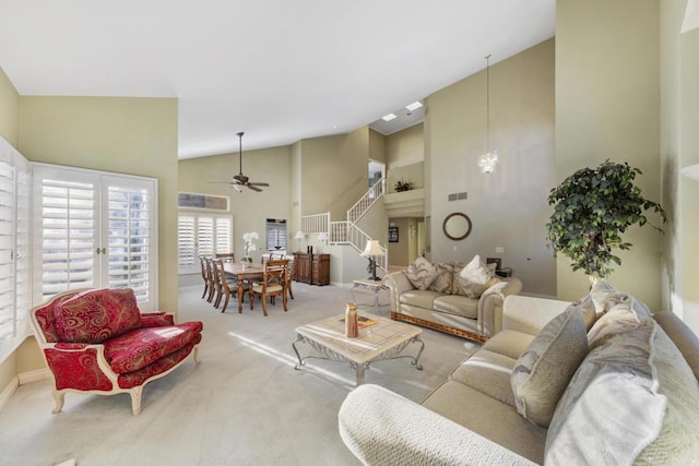 carpeted living room featuring ceiling fan and high vaulted ceiling