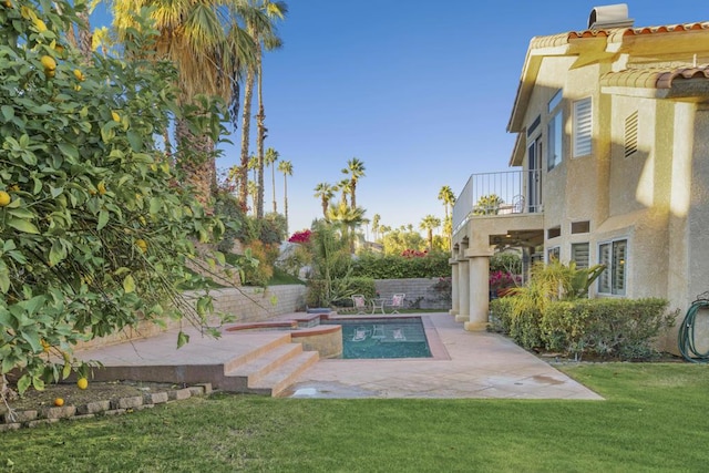 view of swimming pool with a lawn and a patio area