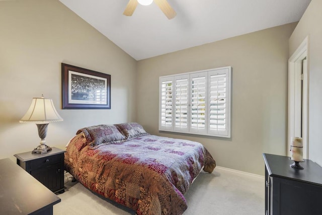 carpeted bedroom with ceiling fan and vaulted ceiling