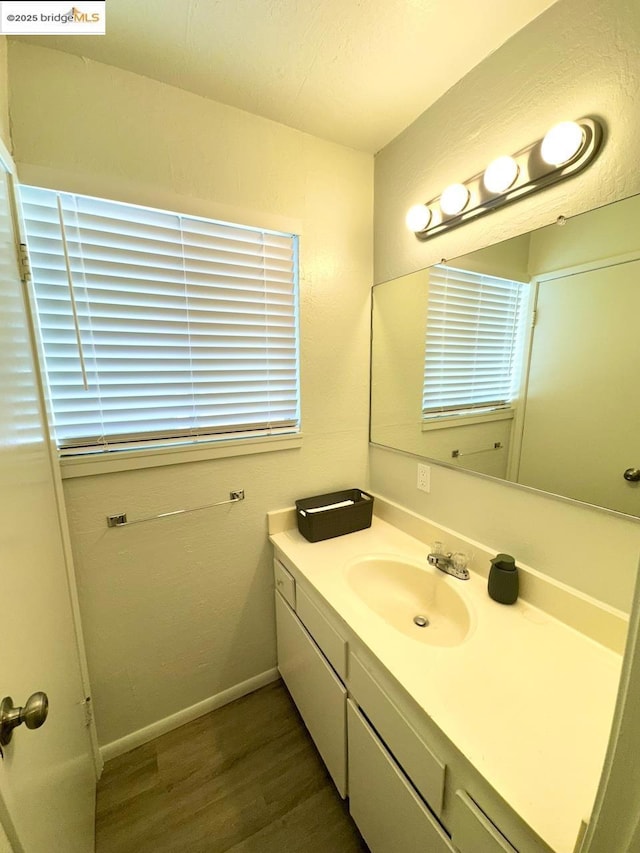 bathroom with hardwood / wood-style floors and vanity