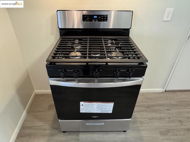 details featuring gas range and light hardwood / wood-style floors