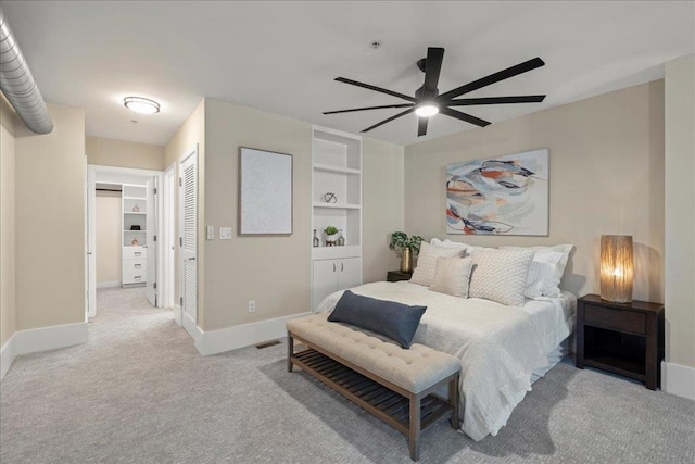 bedroom featuring ceiling fan, light colored carpet, and a closet