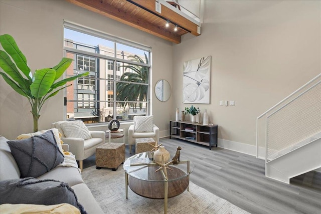 living room with beam ceiling, hardwood / wood-style floors, and wooden ceiling