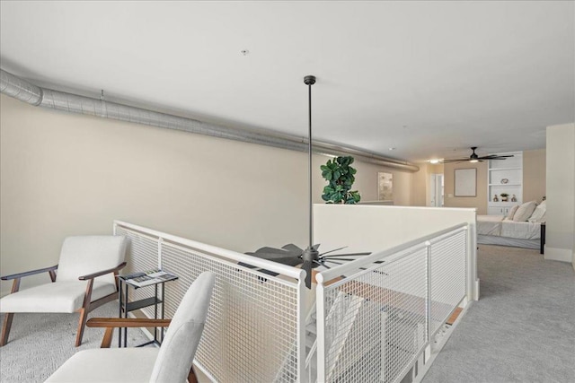 interior space with ceiling fan and carpet flooring