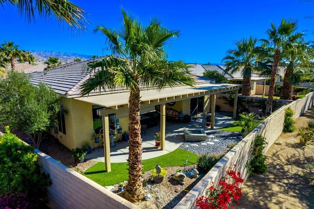 rear view of property with a mountain view and a patio