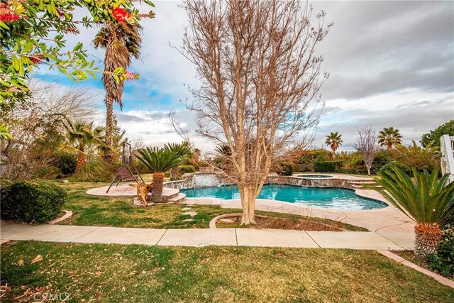 view of pool featuring an in ground hot tub, a yard, and a patio