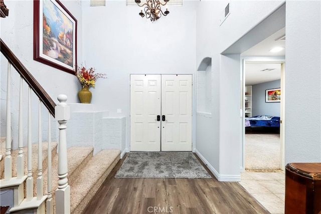 entryway featuring hardwood / wood-style floors and a high ceiling