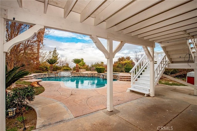 view of pool featuring a patio area and an in ground hot tub