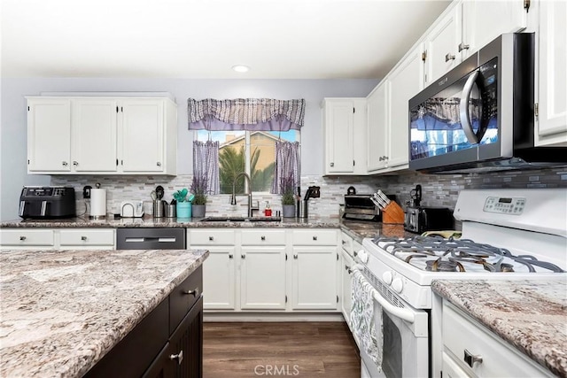 kitchen with light stone countertops, white cabinets, and appliances with stainless steel finishes