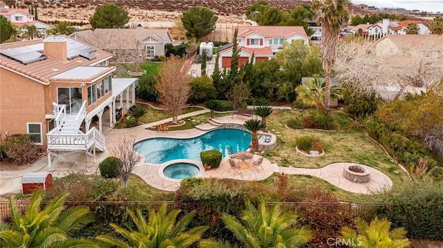 view of swimming pool featuring an in ground hot tub, a patio, and a fire pit