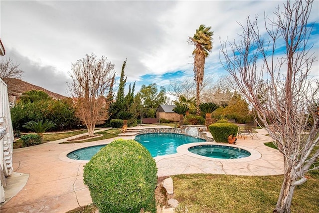 view of pool with an in ground hot tub, pool water feature, and a patio area