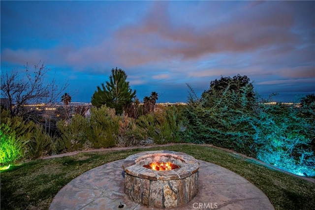 patio terrace at dusk featuring a fire pit