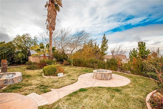 view of yard with a patio area and an outdoor fire pit