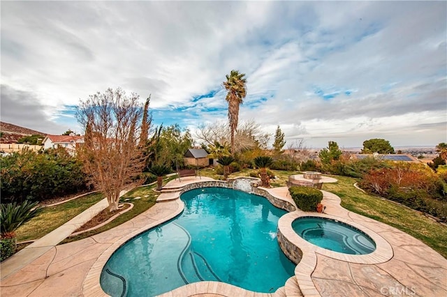 view of pool with an in ground hot tub, pool water feature, and a patio area