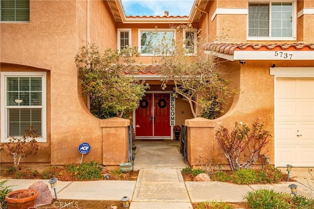 view of exterior entry featuring a garage