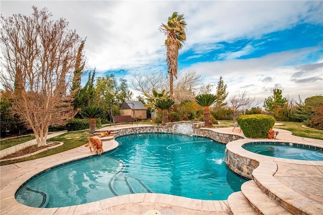 view of pool with pool water feature and an in ground hot tub