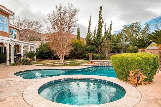 view of pool with an in ground hot tub, grilling area, and a patio