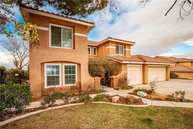 mediterranean / spanish-style house featuring a garage and a front yard