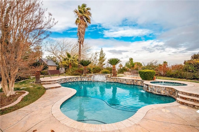 view of swimming pool featuring an in ground hot tub, pool water feature, and a patio