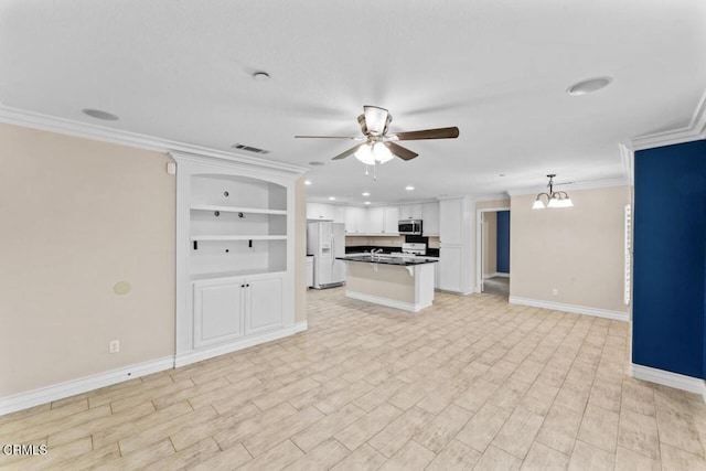 unfurnished living room featuring built in shelves, crown molding, ceiling fan with notable chandelier, and light wood-type flooring