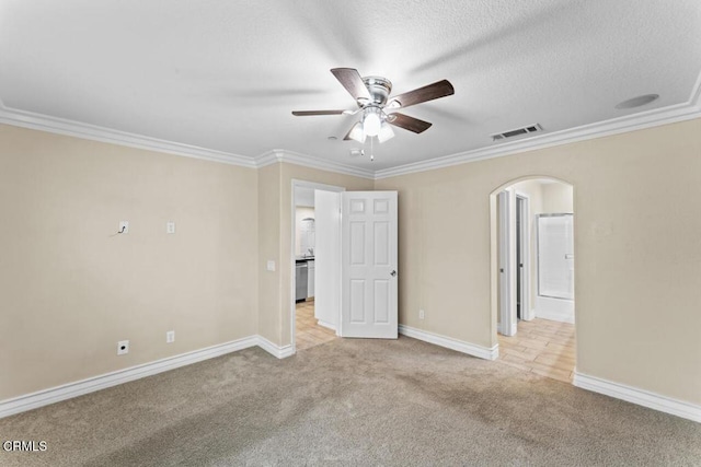 spare room with crown molding, light carpet, and ceiling fan