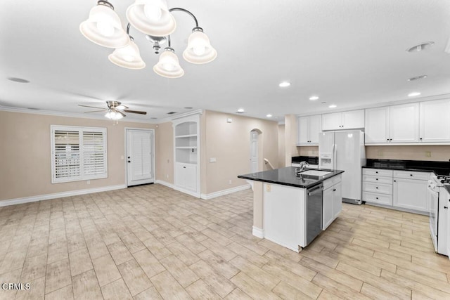 kitchen featuring pendant lighting, white appliances, white cabinetry, and sink