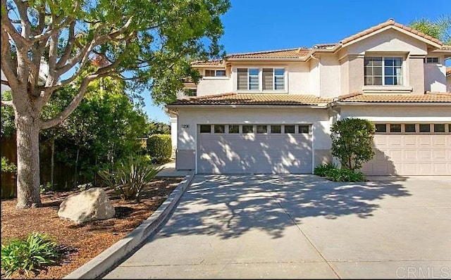 mediterranean / spanish-style house with a garage