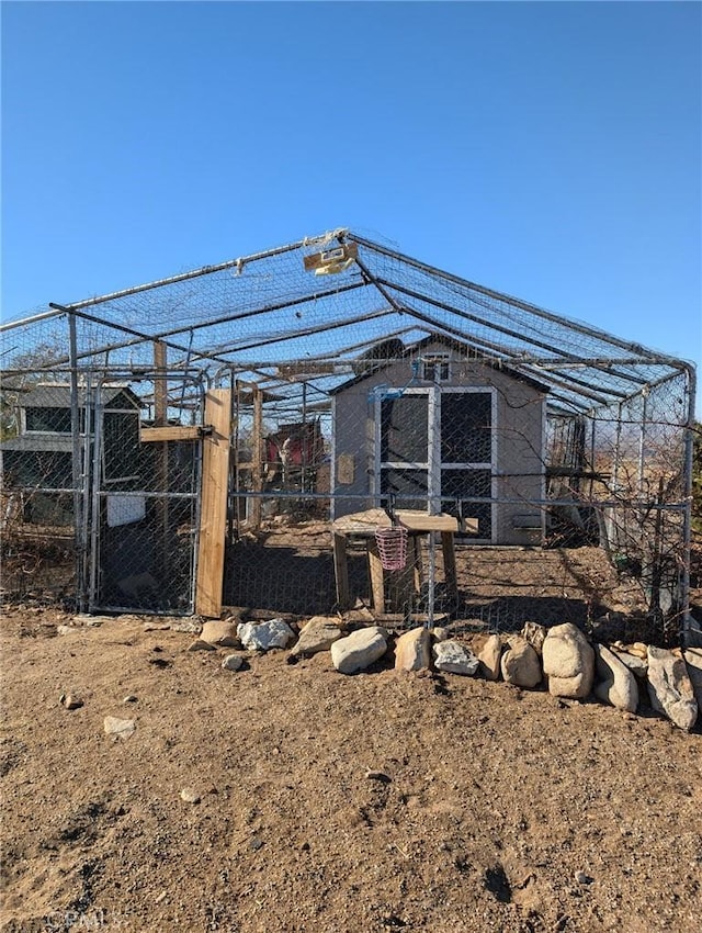 back of property with an outdoor structure