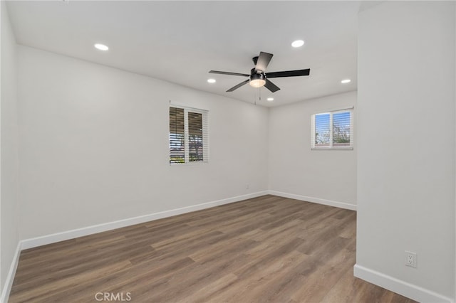 empty room with ceiling fan and hardwood / wood-style floors