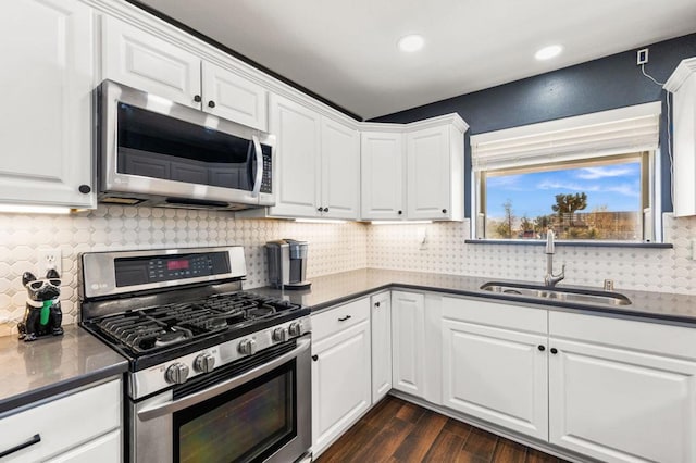 kitchen with white cabinets, appliances with stainless steel finishes, and sink