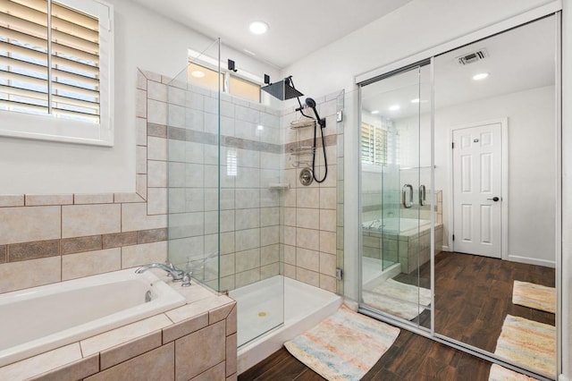 bathroom with plus walk in shower and wood-type flooring